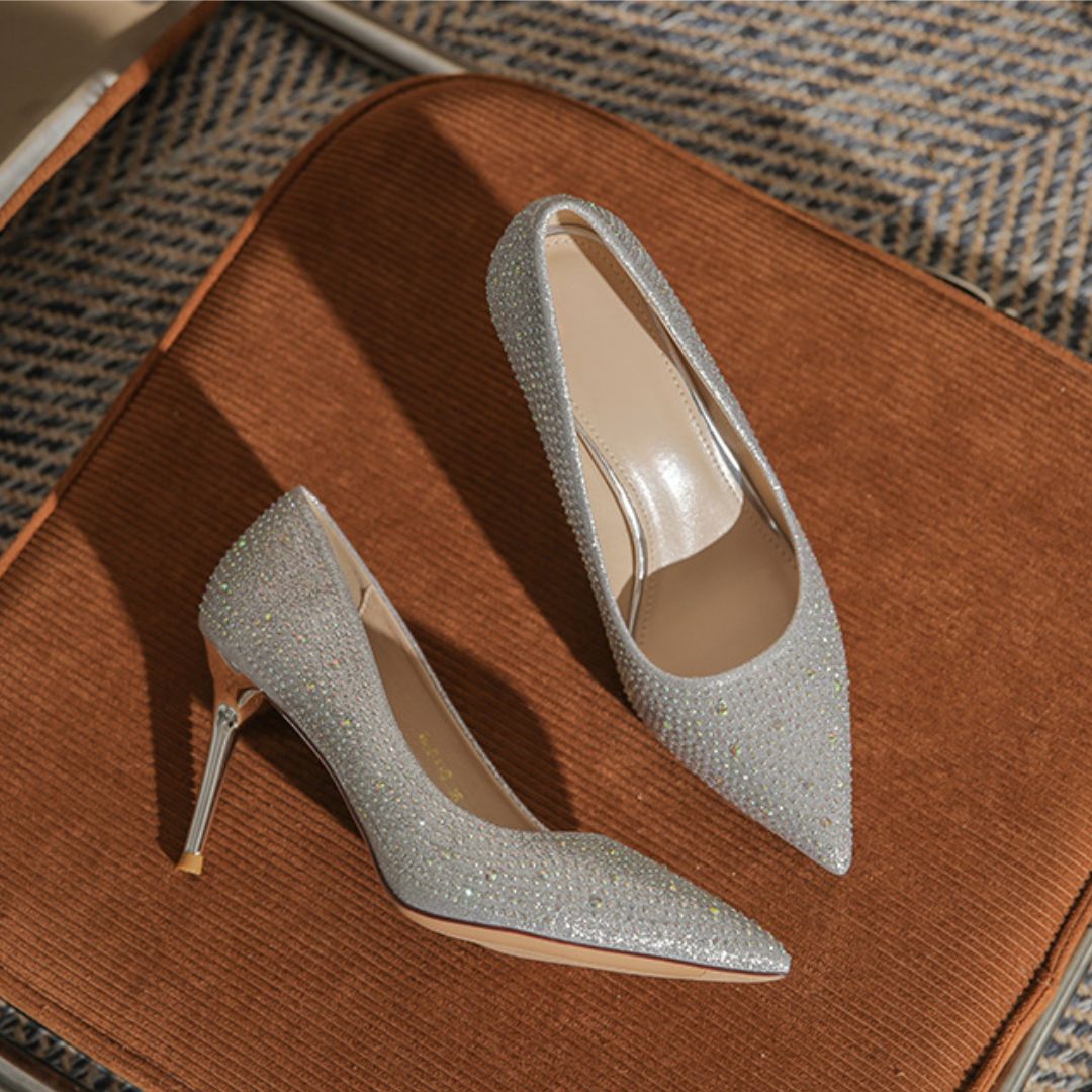 Silver glitter high heels on a brown surface