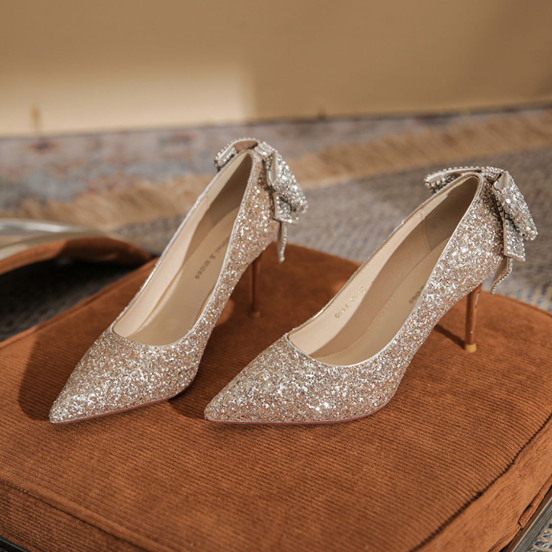 Anmol champagne shimmer bridal stiletto heels with rhinestone bow - front view